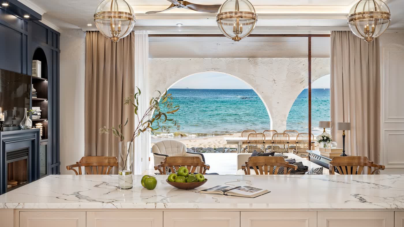 A'ila villa interior opening onto the sea through arches