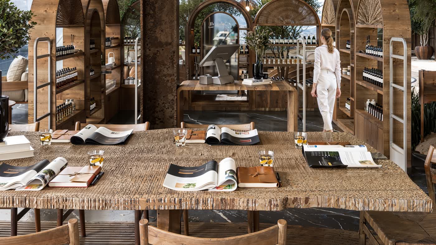 A'ila wellness room — woven table and arched timber