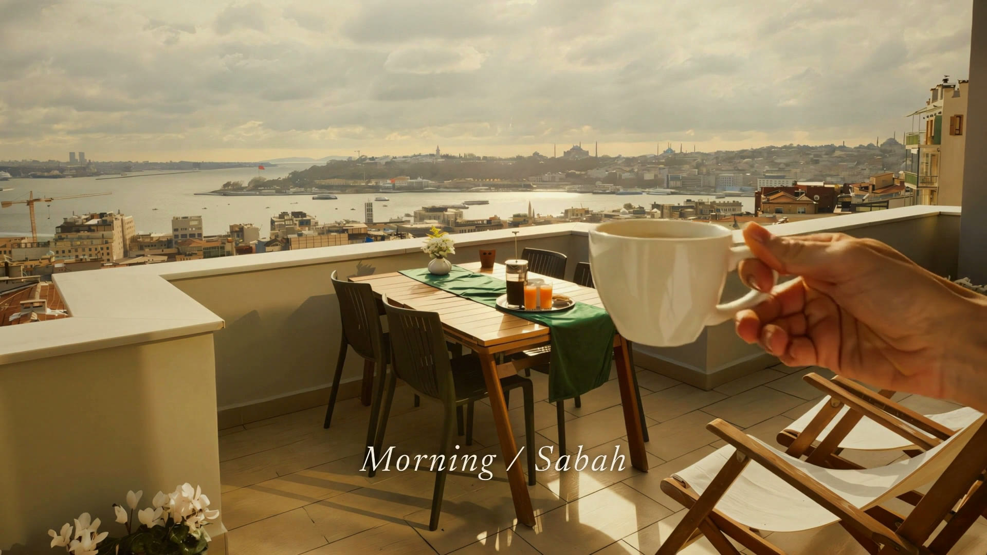 Frame at 0:09 — The şerefe. The property's own terrace photograph, brought into motion and held against the sunset — the closing beat the whole fall exists to earn.