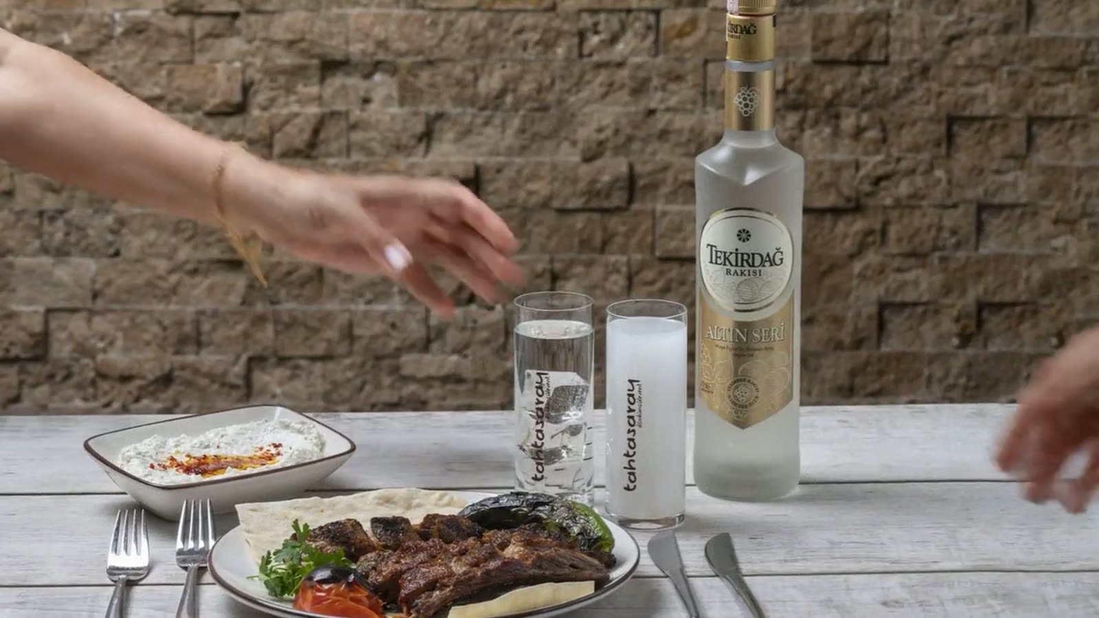 Frame at 0:04 — First pairing wide. The dish establishes the rakı; the camera doesn't show both yet. The audience waits.